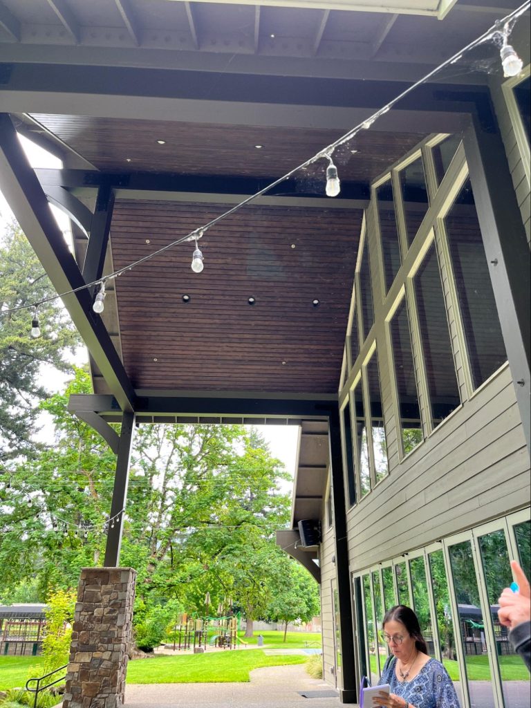 The covered back patio of the main hall. The covering is a permanent roof extended from the main structure, and has embedded lighting.